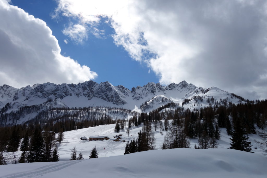 La cresta dei Tudai di Razzo dalla strada per Casera Sottopiova; Baita Ciampigotto e, più a sinistra, rifugio Ten. Fabbro